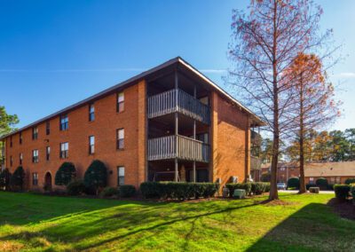 . A view of the apartment complex at The Reserve at Lakewood, showcasing modern architecture in Lakewood, NC.